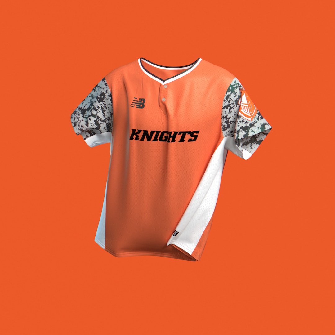 An orange Knights jersey suspended against an orange background.