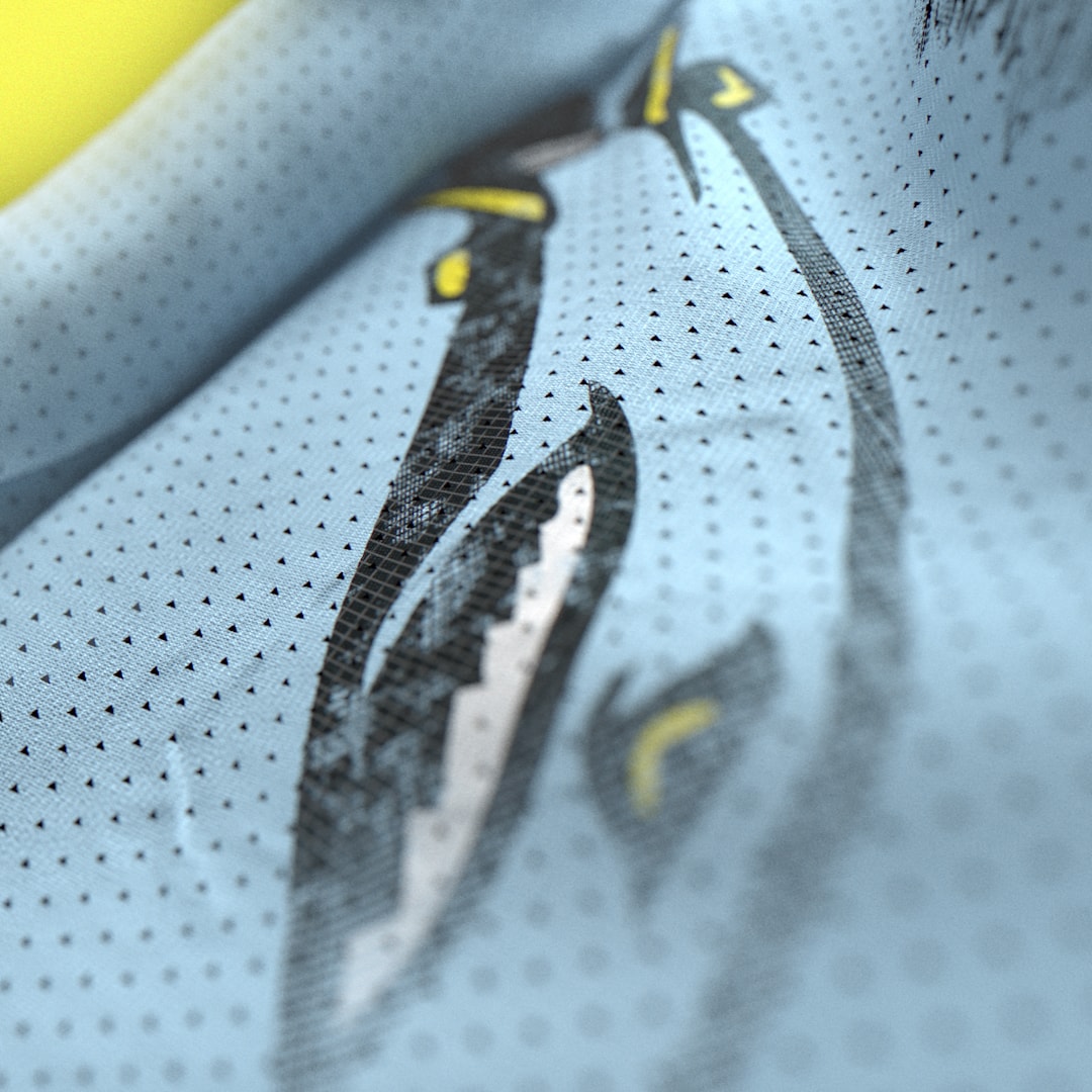 Close-up of textured jersey fabric and a team emblem.