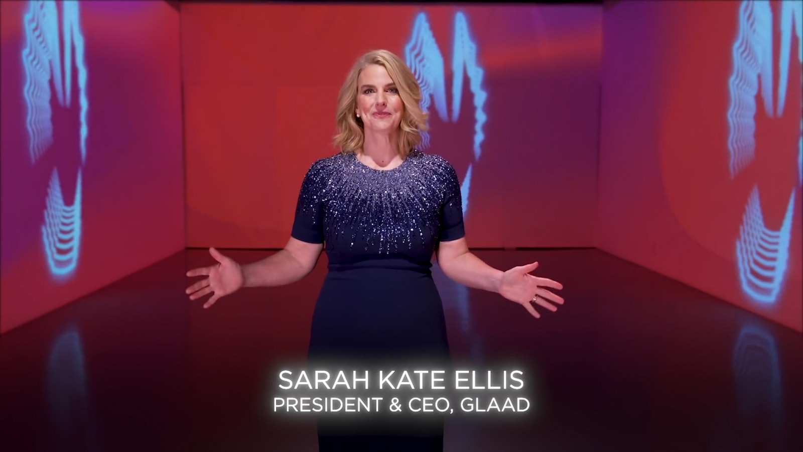 A speaker appears within the red and blue 2021 GLAAD broadcast graphics.