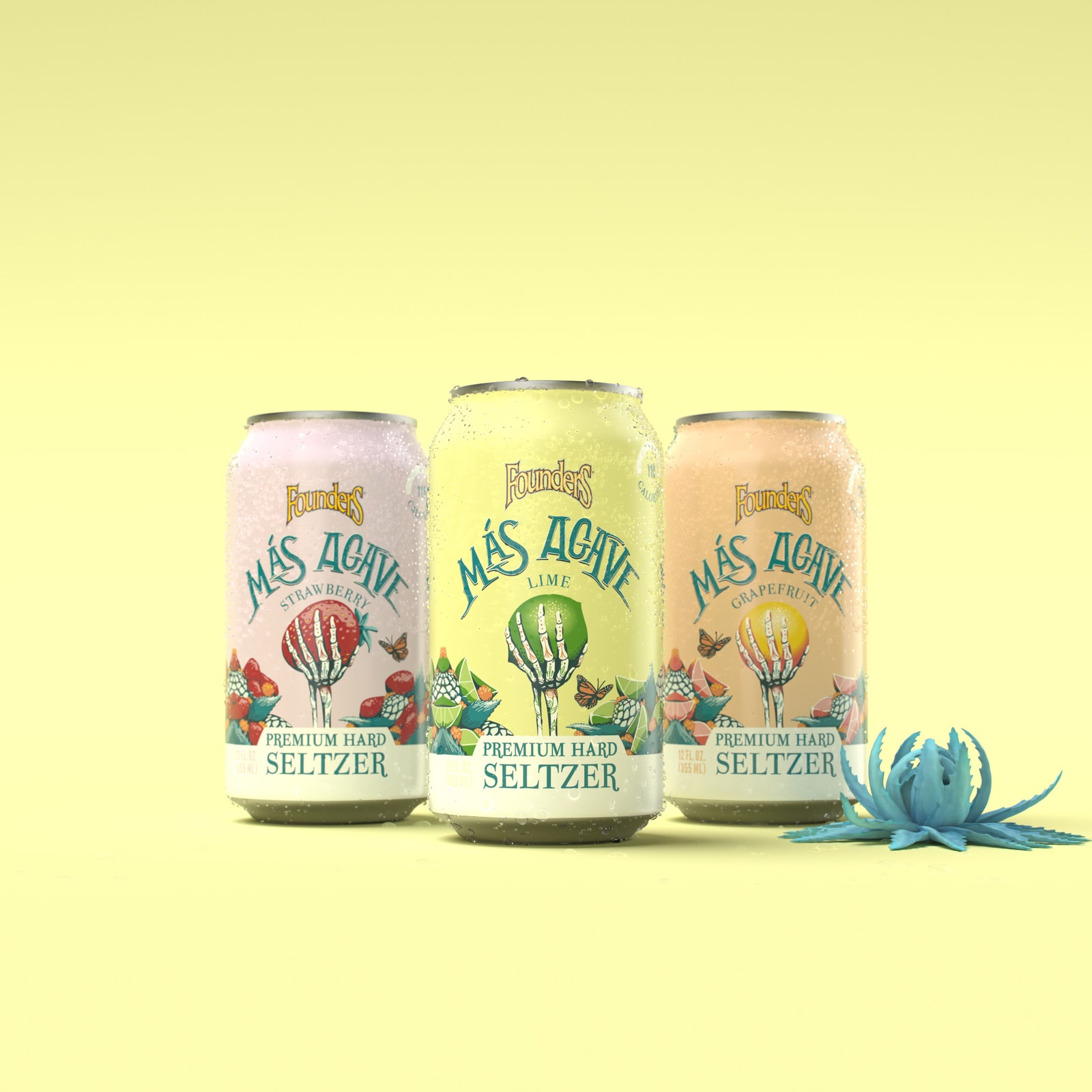 Three Más Agave hard seltzer cans stand against a yellow background.