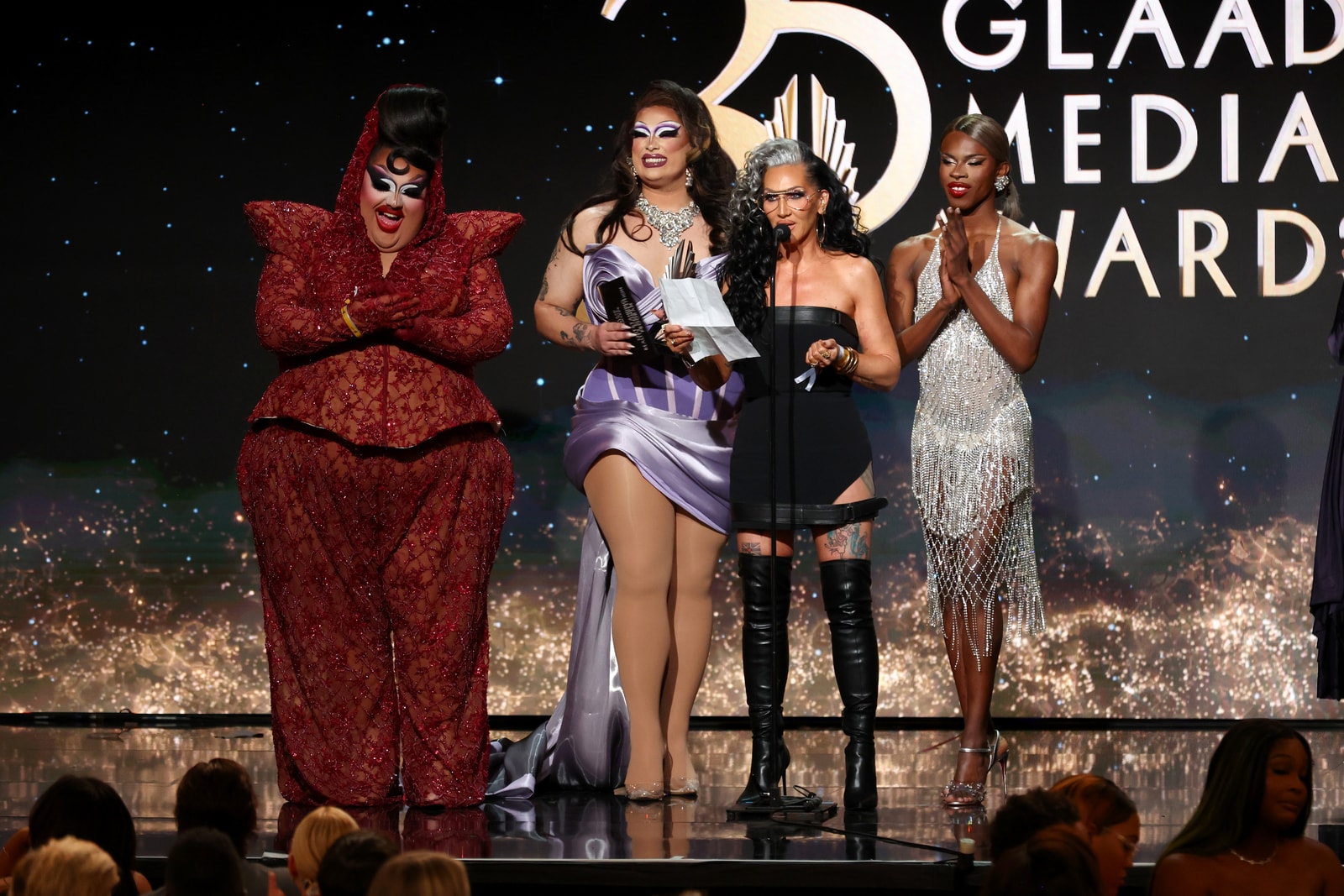 Four guests on stage in front of gold 35th GLAAD Media Awards graphics.