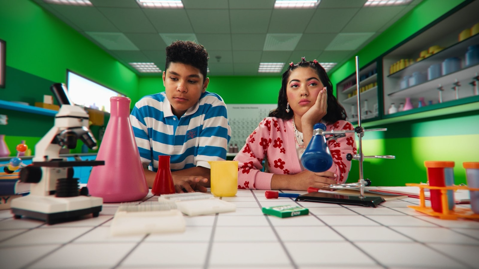 Two students work in a green science lab.