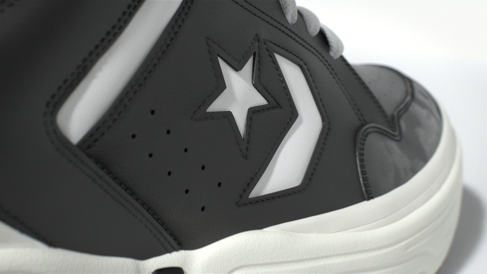 Close-up of the Converse star and chevron on a black sneaker.