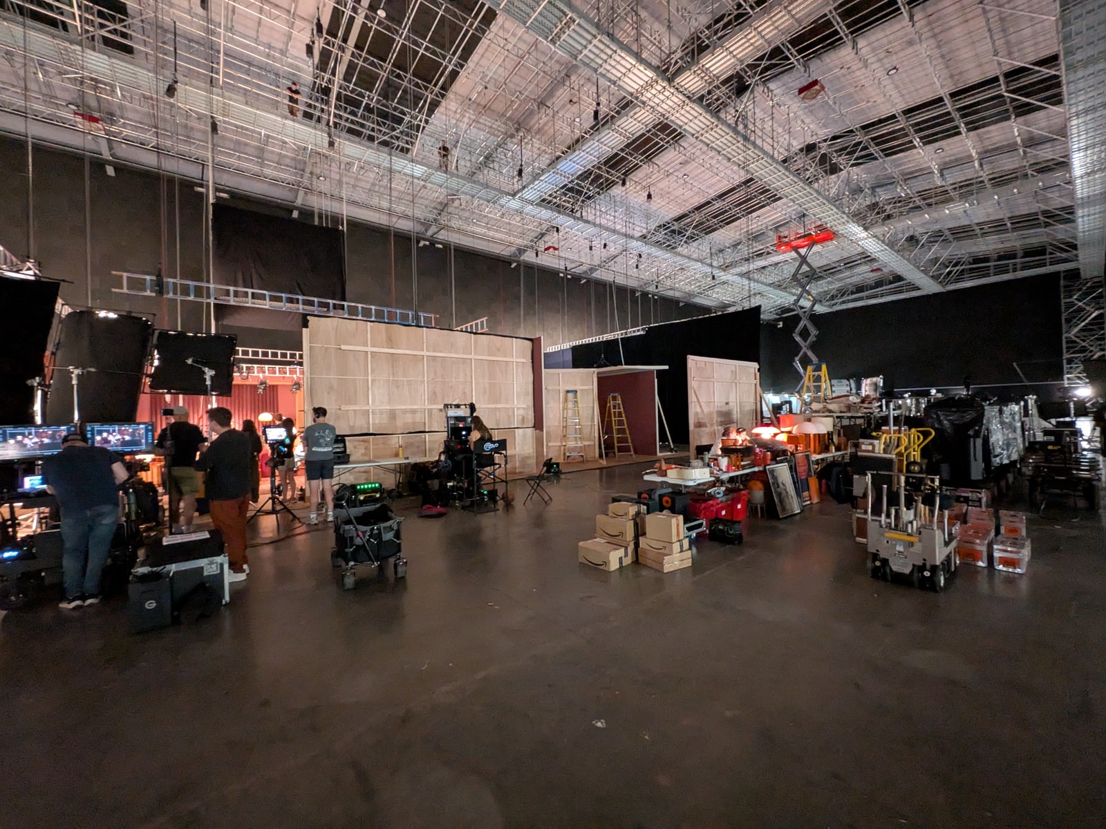 A wide view of the soundstage shows the recording-studio set, overhead rigging, and production equipment.