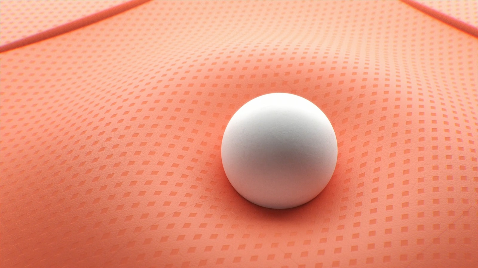 A white sphere presses into a textured coral surface.